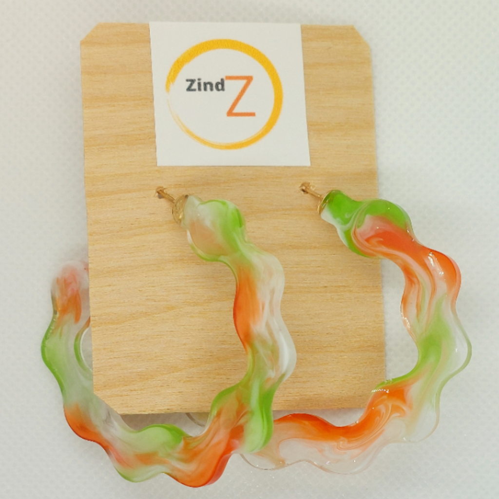 Colorful earrings on a wooden display card with 'Zind Z' branding.