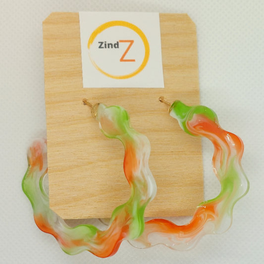 Colorful earrings on a wooden display card with 'Zind Z' branding.